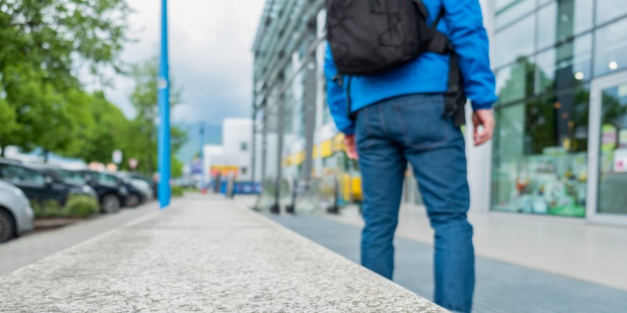 Jeune homme marchant en ville avec un sac à dos sur le dos