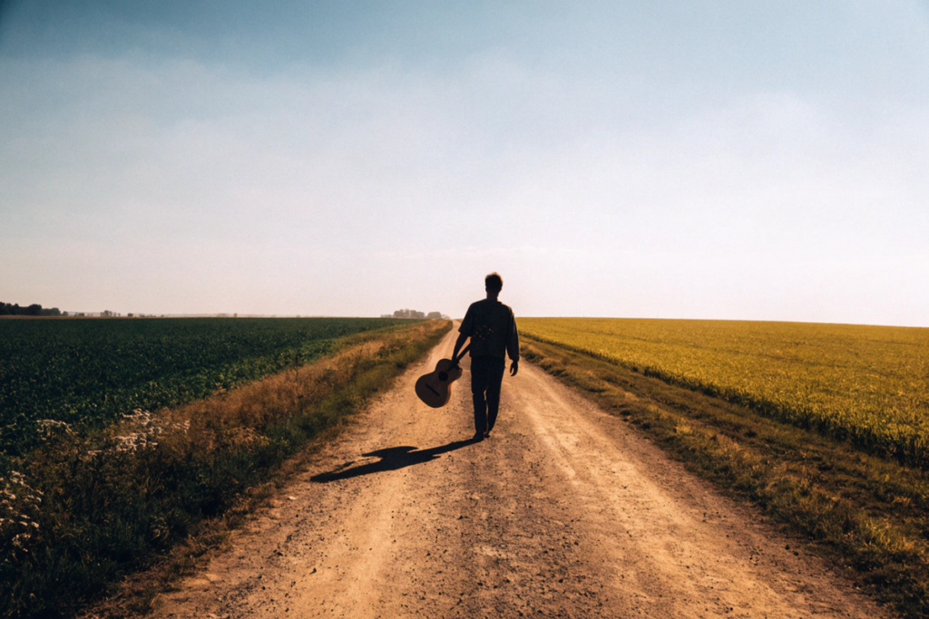 silhouette d’un musicien sur une route de terre rappelant le film Oklahoma Honey
