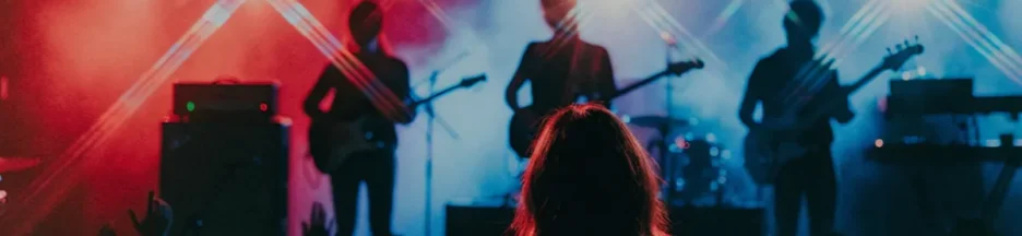 Silhouette d’une jeune femme devant une scène rock énergique évoquant les contrastes sonores du mini-album IMPULSE